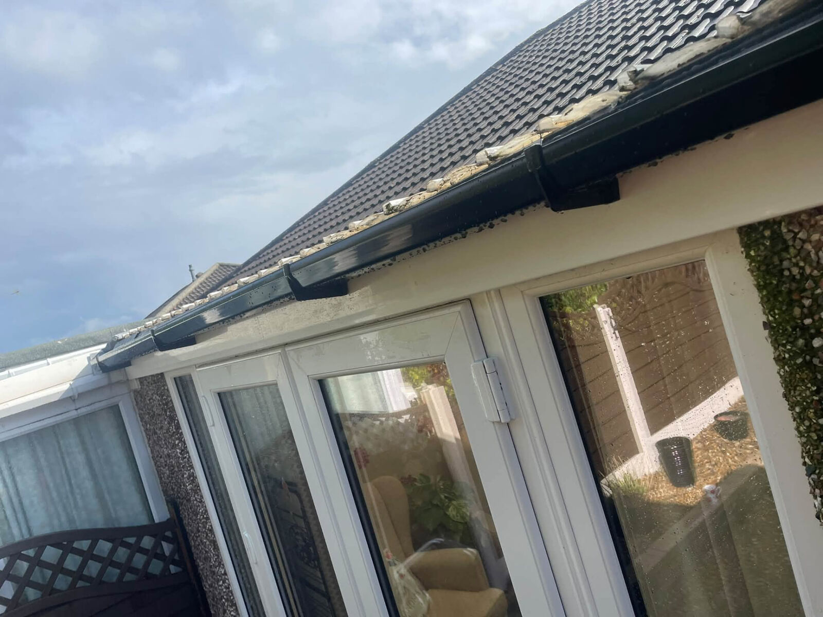 Black guttering along the eaves of a single-storey roof