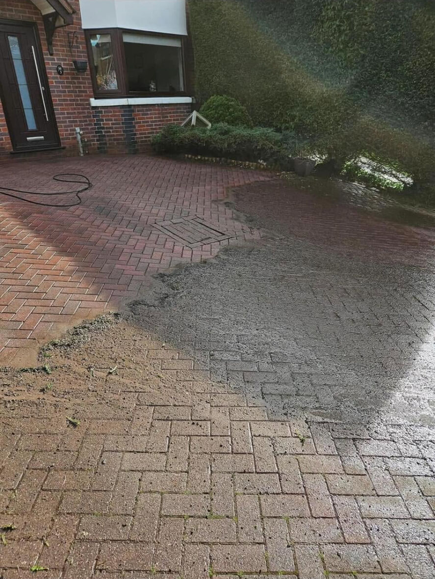 Block paved driveway part-way through pressure washing